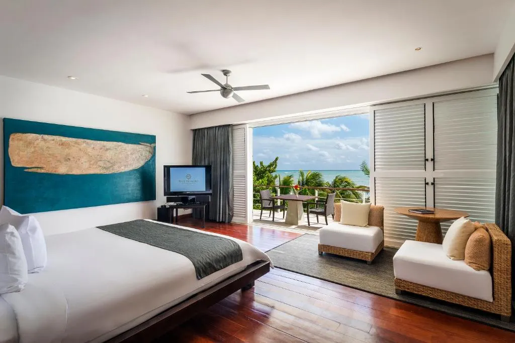 Habitación en Blue Diamond Luxury Riviera Maya con cama king, terraza privada y vista al mar Caribe.